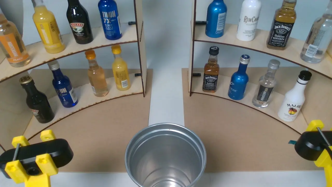 Overhead RealSense view of the bottle shelf, glass, and the two SO-101 gripper arms